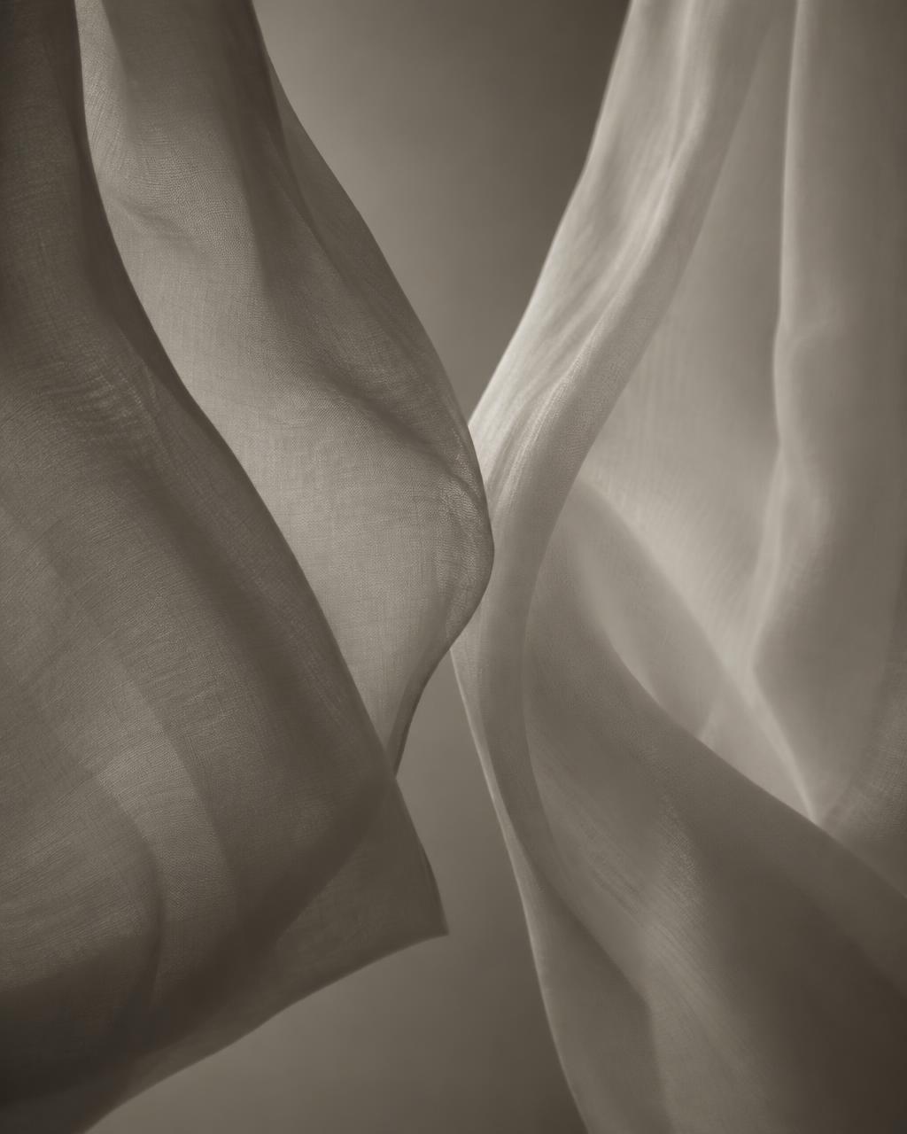 Black and white photograph of two layers of fabric barely touching